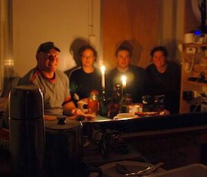 Casey Station Expeditioners use candlelight in a field hut to observe Earth Hour 2009