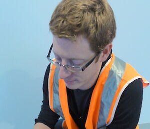 Australian Antarctic Division researcher Chris Ware inspects a pear destined for an Australian Antarctic station.