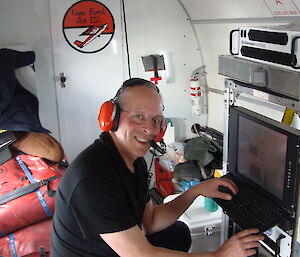 Australian Antarctic Division Glaciologist Tas van Ommen with radar equipment on the plane (Photo: Tas van Ommen)