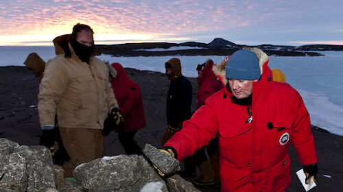 The Mawson station winterers place rocks on the cairn holding Dr Phillip and Nellie Law’s ashes.