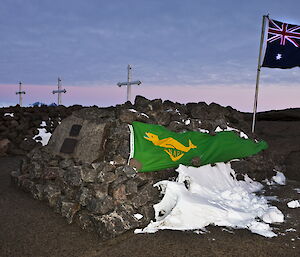 The ANARE and Australian Flag next to the cairn holding Phil and Nel Laws ashes, alongside the graves of other expeditioners who have died at Mawson station.