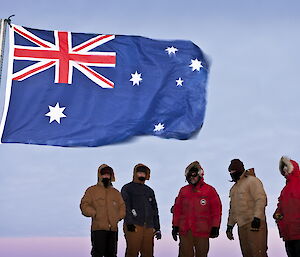 Mawson station winterers in the twilight at the interment ceremony on West Arm.