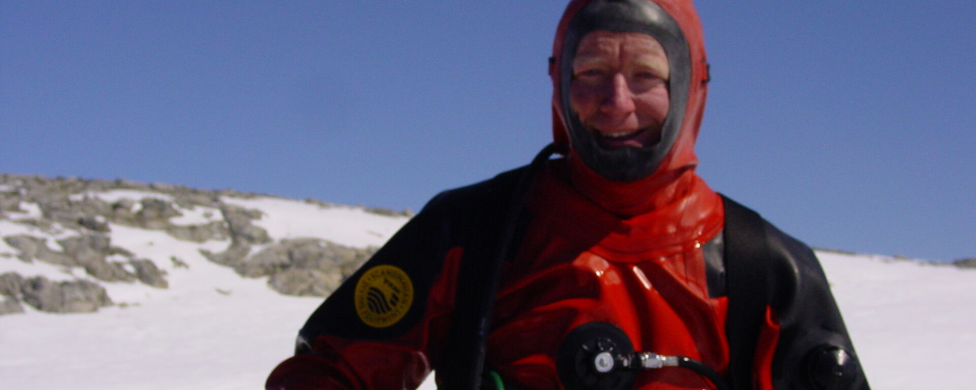 Dr Riddle in a drysuit preparing to dive as part of research into human impacts in Antarctica