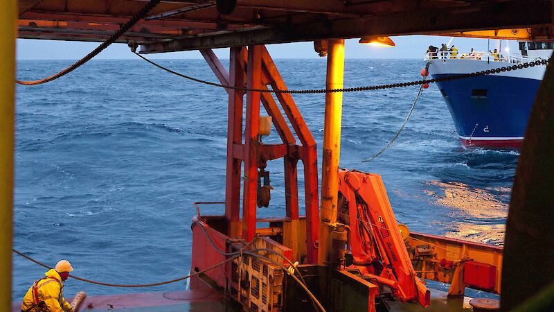 Aurora Australis crew member attaching the tow rope to the F.V. Janas