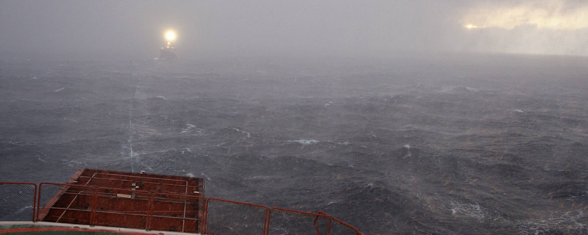 Snow storm obscures the F.V. Janas off the stern of the Aurora Australis