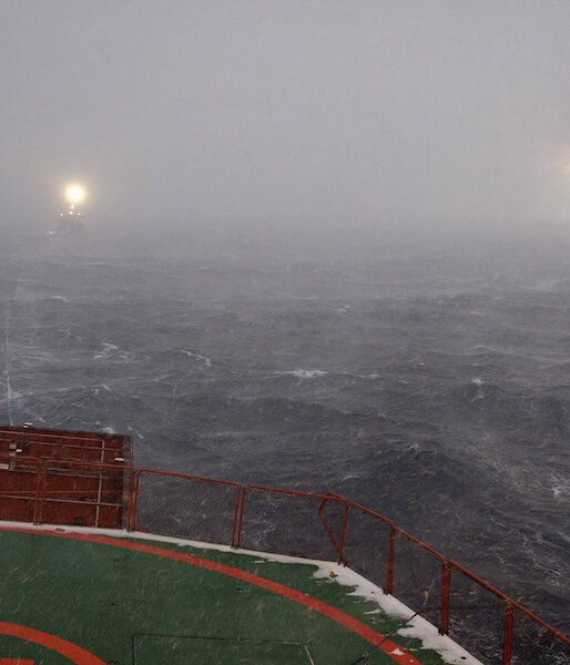 Snow storm obscures the F.V. Janas off the stern of the Aurora Australis
