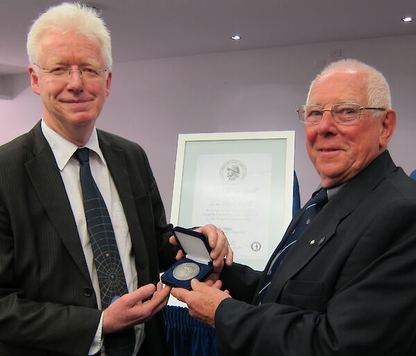 Dr Martin Riddle receives the inaugural Phillip Law Medal from the ANARE club’s Ray McMahon