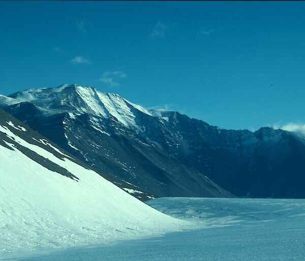 Snow topped mountains with glacial landscape in foreground