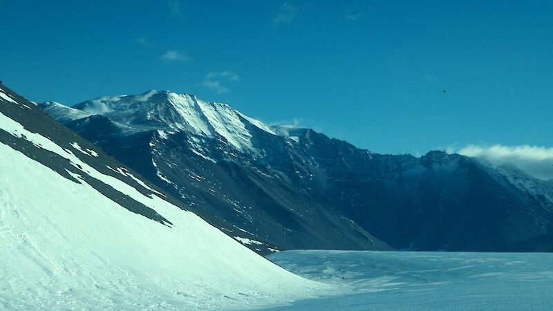 Snow topped mountains with glacial landscape in foreground