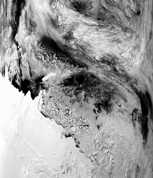 A raw MODIS image showing the Antarctic continent, lower-left corner, and the Southern Ocean. Heavy cloud cover is visible over much of the image.