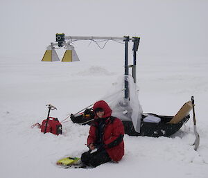 Scientist, Natalia Galin, measures snow thickness using a sled-based radar.