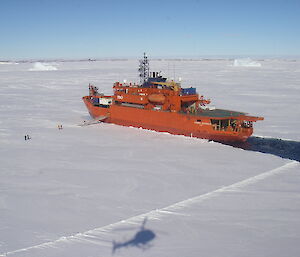 A helicopter shadow is visible on the ice floe as it prepares to test the radar, as the Aurora Australis waits nearby.