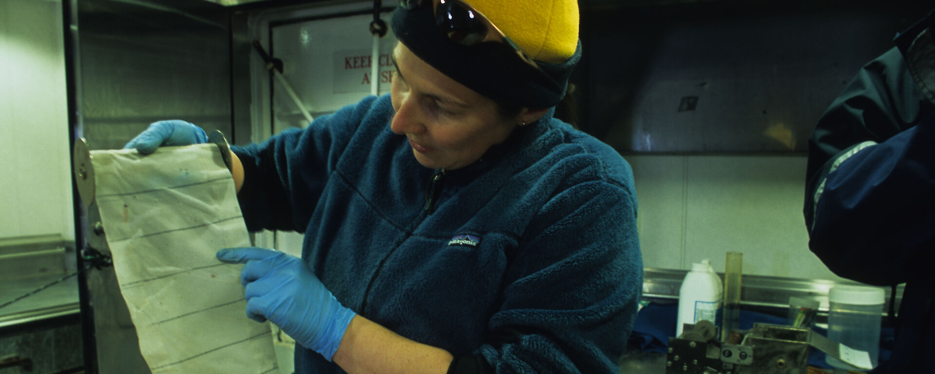 Expeditioner reading results from the Continuous Plankton Recorder