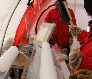 Glaciologist Tessa Vance with ice core at Law Dome in Antarctica