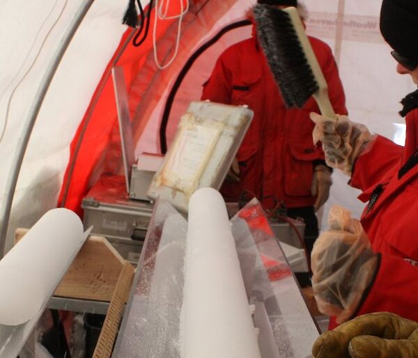 Glaciologist Tessa Vance with ice core at Law Dome in Antarctica