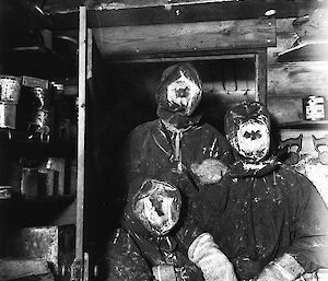 Photograph of three men with partial ice masks