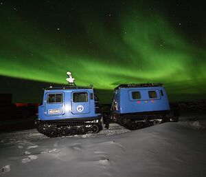 Davis Station Hägglunds with aurora overhead