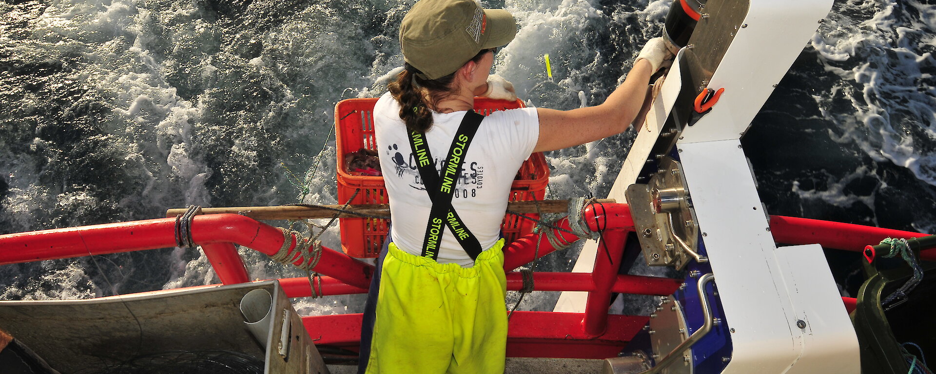 The Underwater Bait Launcher being used by fisher on the back of a boat