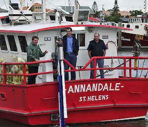 The bait launcher on the stern of the F/V Annandale leaving Mooloolaba with engineers (L-R) Ian Carlyle, Phil Ashworth and Peter Ashworth preparing for sea trials