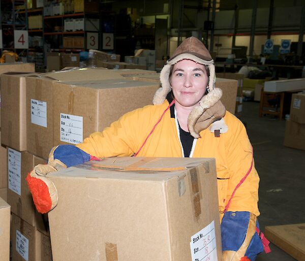 Warehouse and Distribution Supervisor, Amber Martyn, holds a box of donated clothing