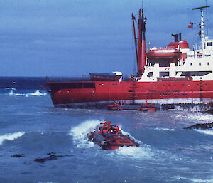 Nella Dan aground at Macquarie Island with LARCs removing valuable cargo from ship