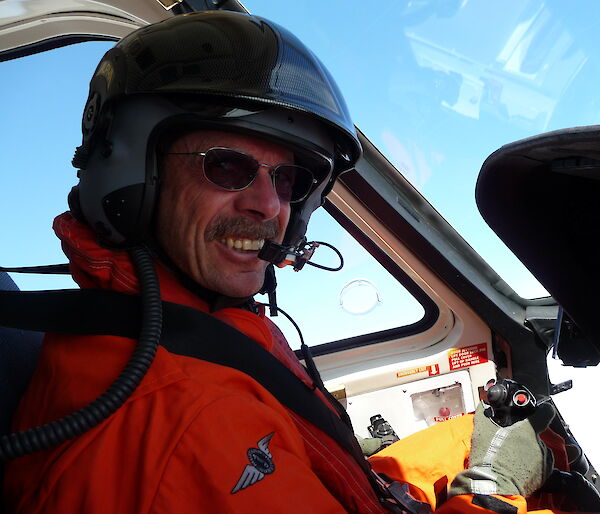 David Pullinger, winner of the 2009 Antarctic Medal, piloting a helicopter.