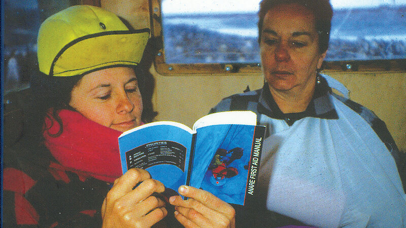 First Aid Manual cover — image of two women reading previous edition.