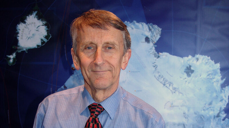 Chief Scientist, Professor Michael Stoddart, poses in front of map of Antarctica