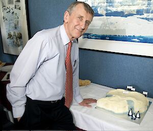 Professor Stoddart poses with an Antarctic-shaped cake