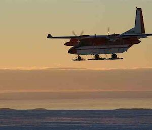 C-212 aircraft flying over Lanyon Junction skiway