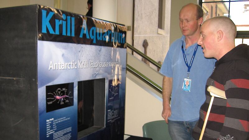 Marine scientist Rob King (left) discusses Antarctic krill with a visitor.
