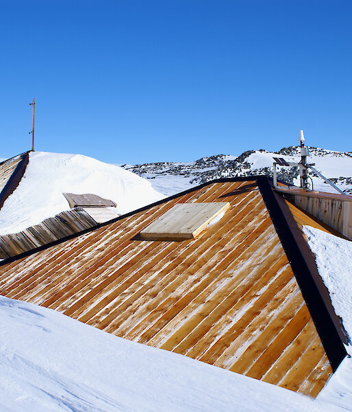 After — overcladding of the main hut roof in progress