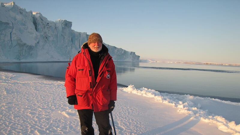 Station leader stands in the snow.