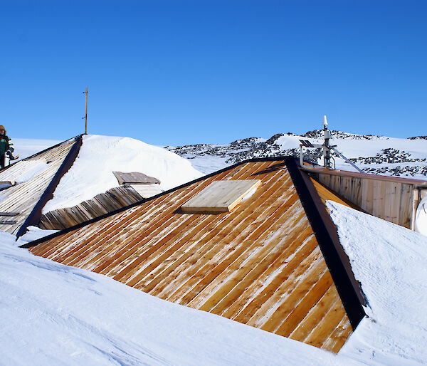 After restoration work, overcladding of the main hut roof in progress