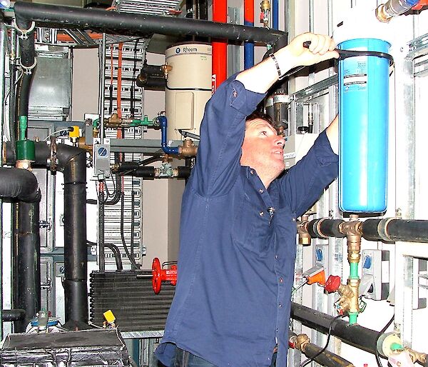 Plumber at work changing a water filter