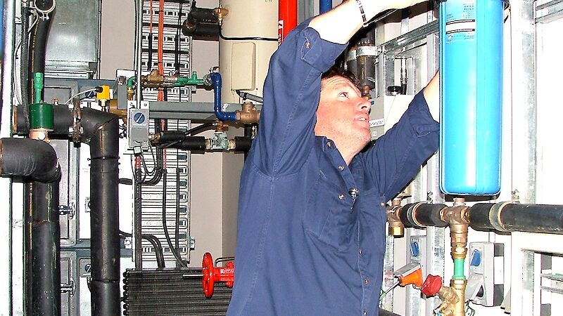 Plumber at work changing a water filter