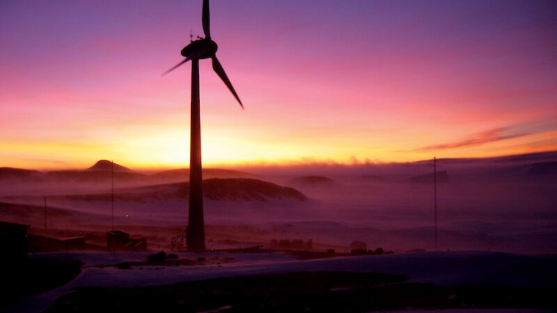 Wind turbine with sunset in the background