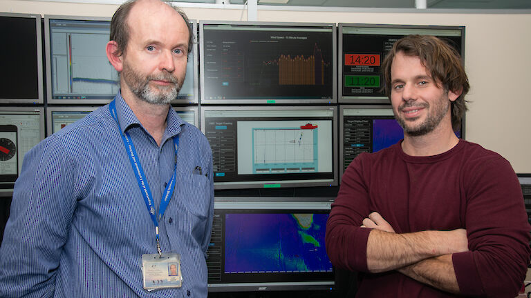 Lloyd Symons (left) and Michael Santarossa in front of computer screens set up to mimic the Aurora Australis science control room and deliver ‘data in real time’ (DiRT).