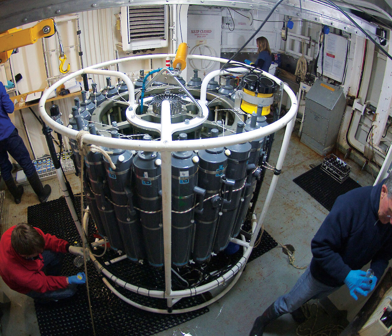 Four scientists attending a Conductivity Temperature and Depth probe in the CTD room of the Aurora Australis.