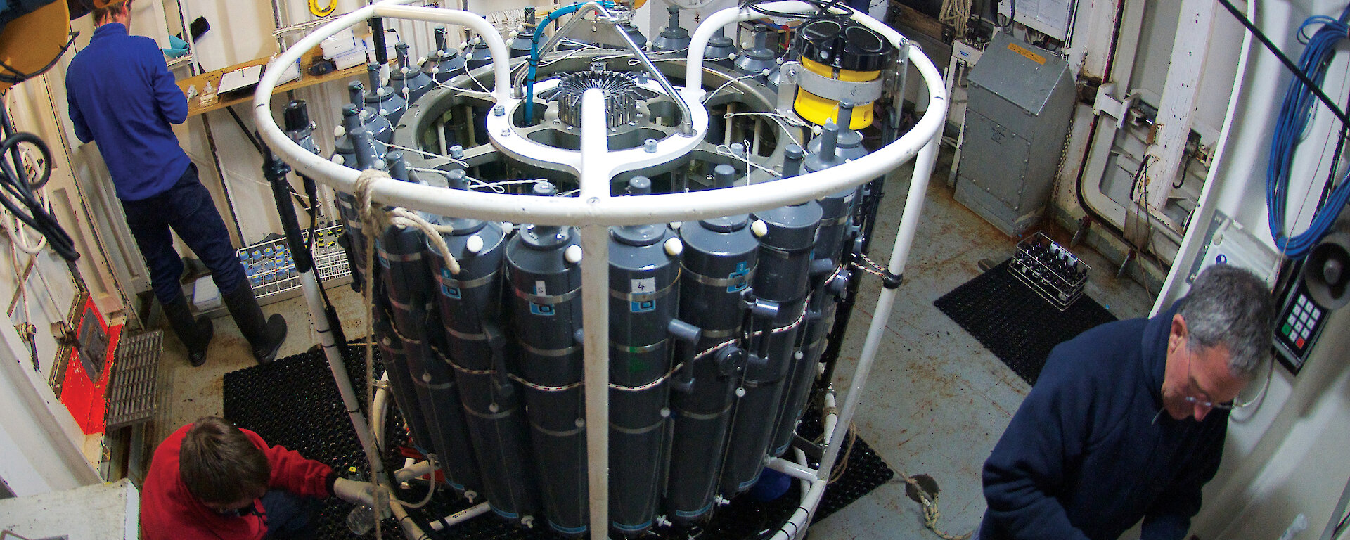 Four scientists attending a Conductivity Temperature and Depth probe in the CTD room of the Aurora Australis.