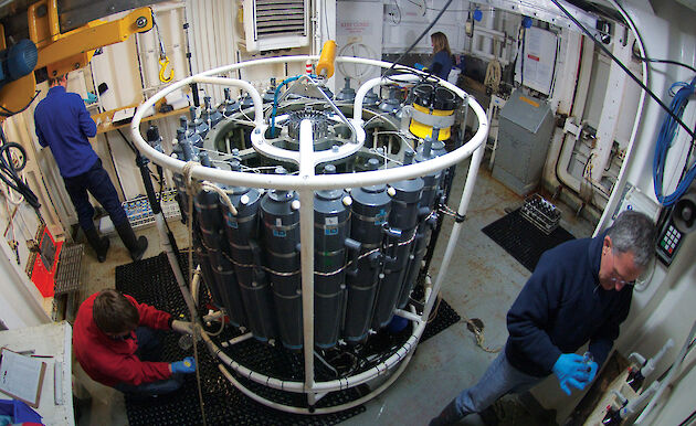 Four scientists attending a Conductivity Temperature and Depth probe in the CTD room of the Aurora Australis.