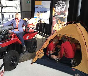 Children on a quad bike and inside a polar tent.