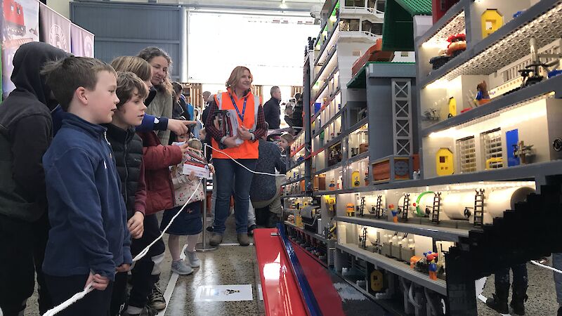 Children look at the LEGO model of an icebreaking ship.