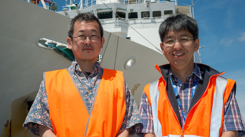 Two scientists, Tokyo University’s Dr Masato Moteki and Australian Antarctic Division’s Dr So Kawaguchi, on the dock next to the Japanese ship the Umitaka Maru
