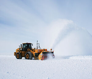 Plant machinery blowing snow clear of the runway