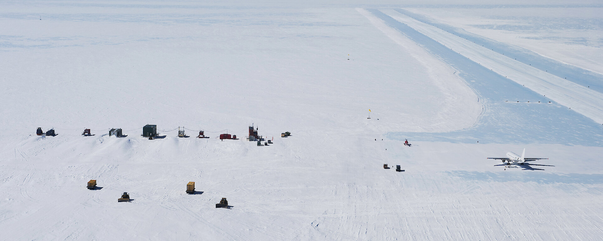 Photo of blue ice runway with plane