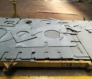 Pieces of steel plate cut into shapes.