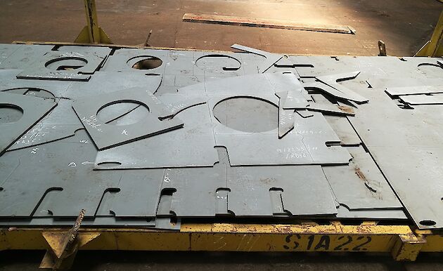 Pieces of steel plate cut into shapes.