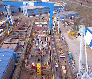 The base of the ship’s hull takes shape in the dry dock at Damen Shipyards in Romania
