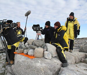 Media crew interviewing scientists at an Adelie penguin colony on Shirley Island